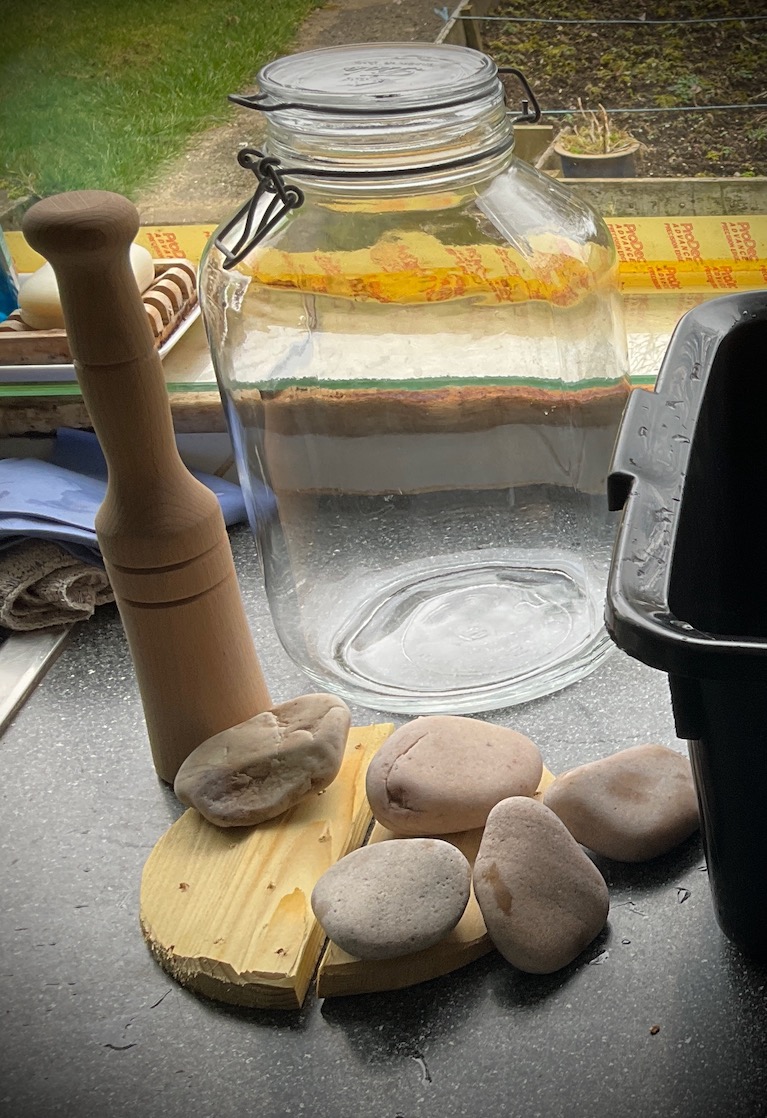 Large glass jar, wooden boards and stones